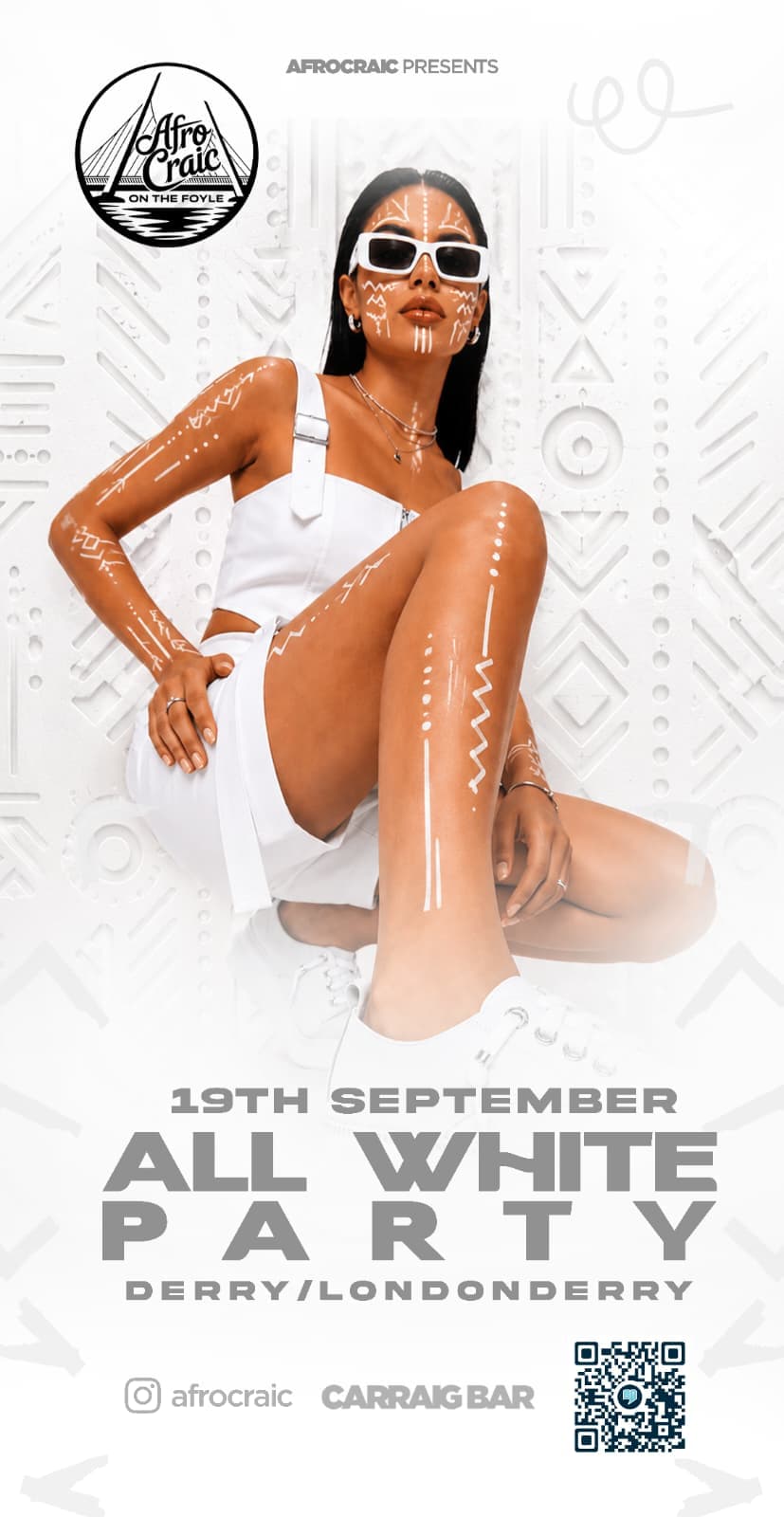 Model in an all-white look against a patterned white background